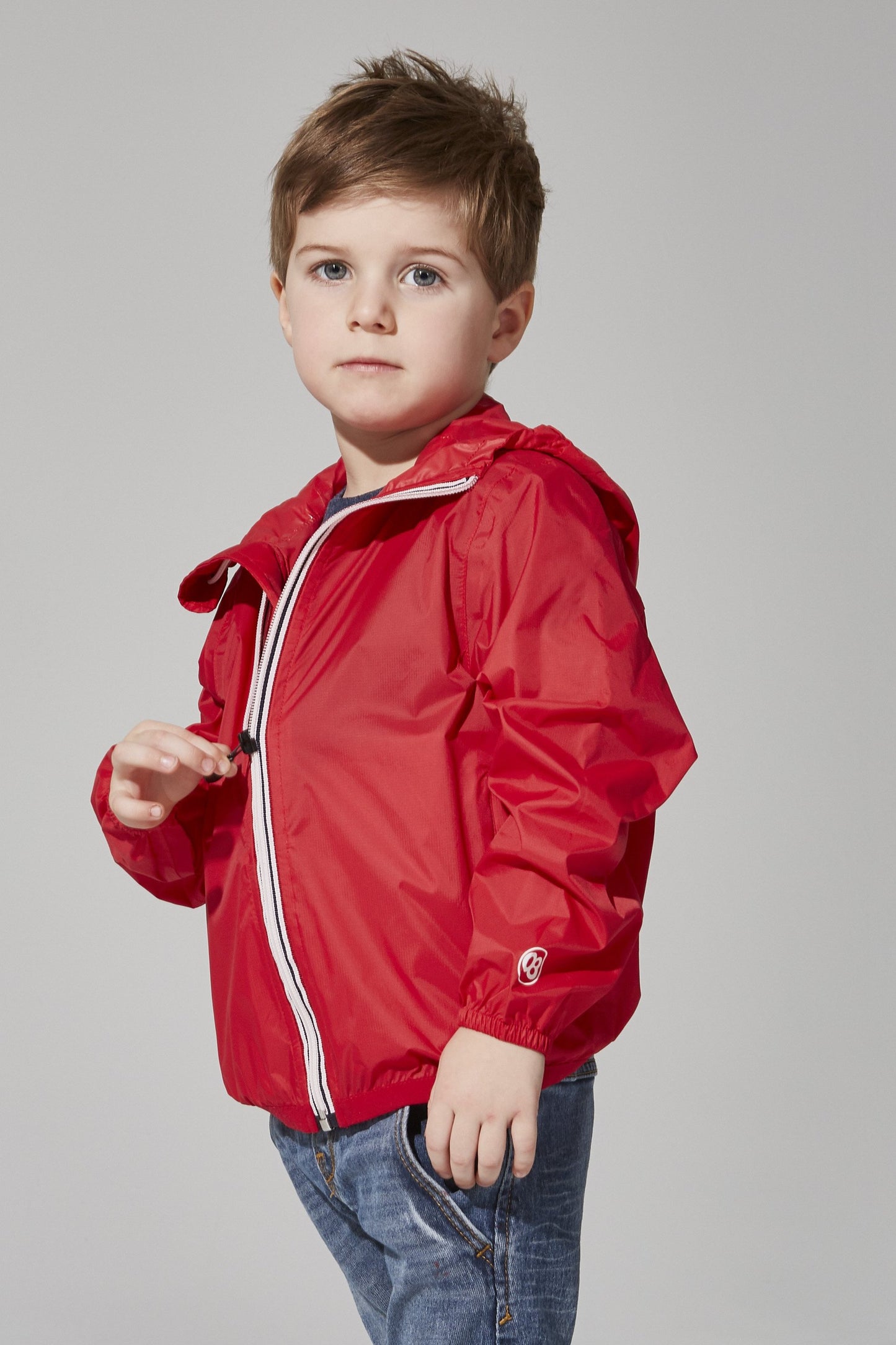 Kids red full zip packable rain jacket and windbreaker